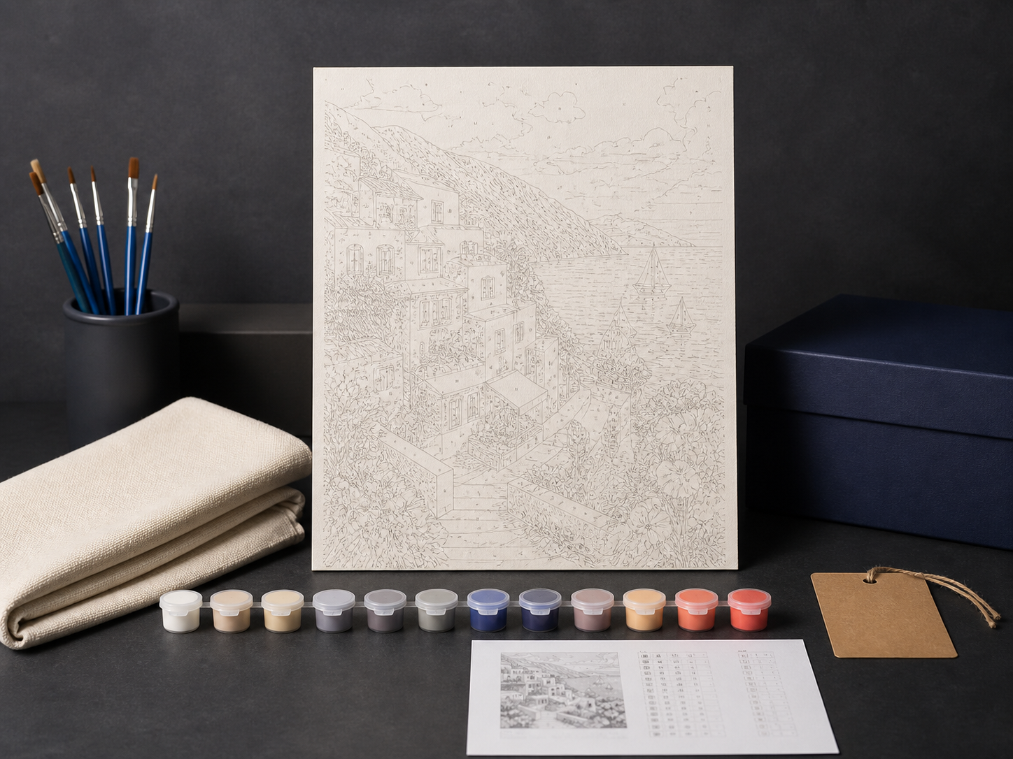 A scheme, canvas sample, paints, and materials prepared for kit inspection